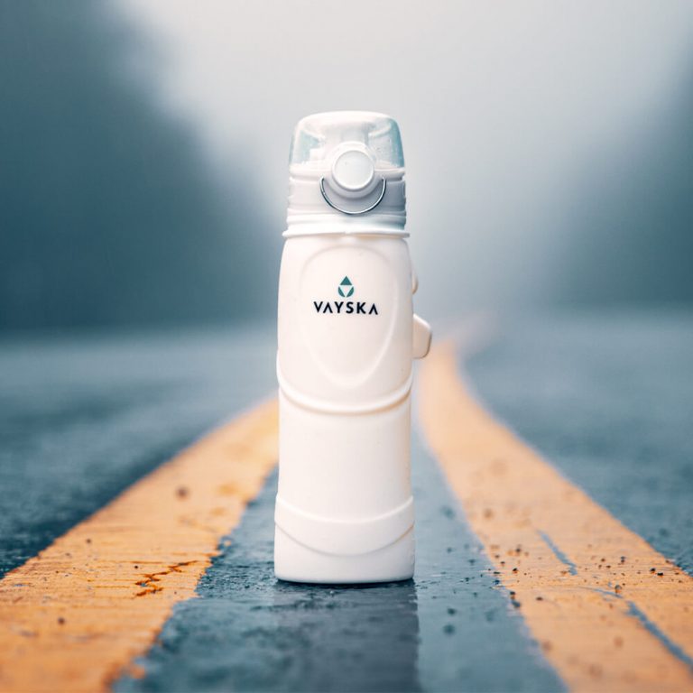 The Vayska 25 ounce water bottle. Air tight lid with a lock, so it never spills in your bag. The bottle (and the photographer) are sitting in the middle of the road. Dangerous, we know. We had people looking for traffic. No bottles (or photographers) were harmed in the making of this photo.